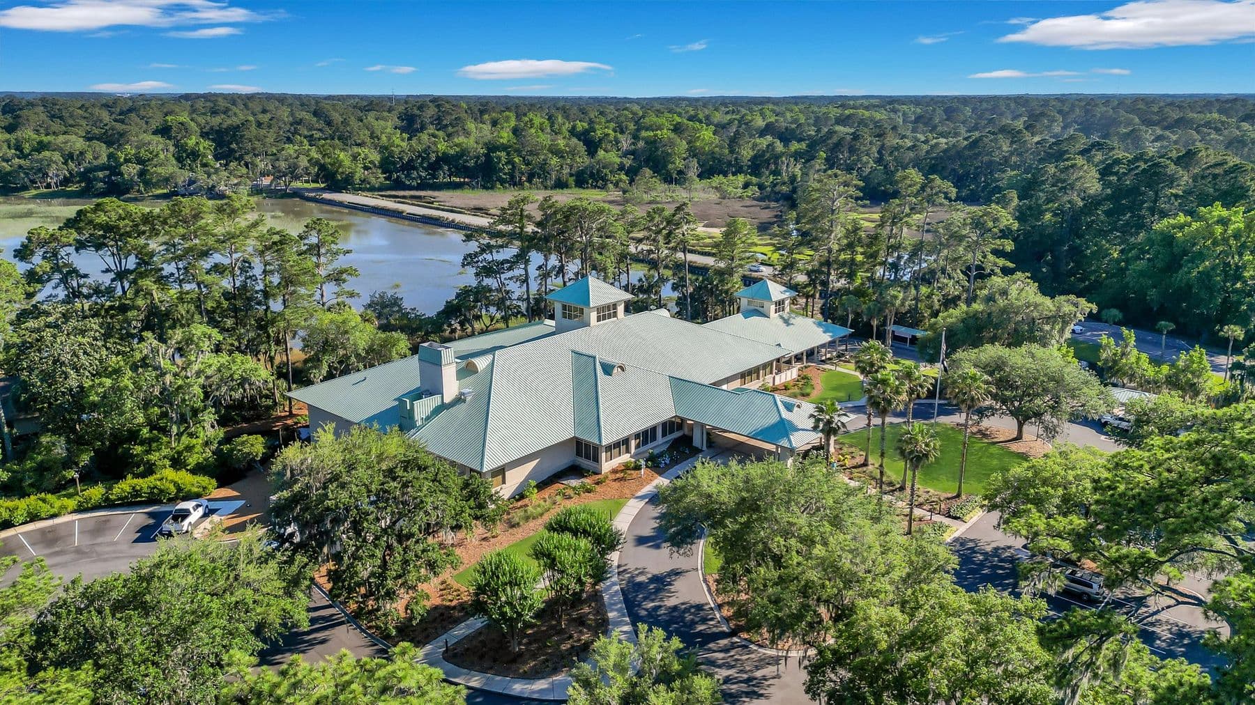 Aerial view of the Moss Creek clubhouse and grounds among live oaks