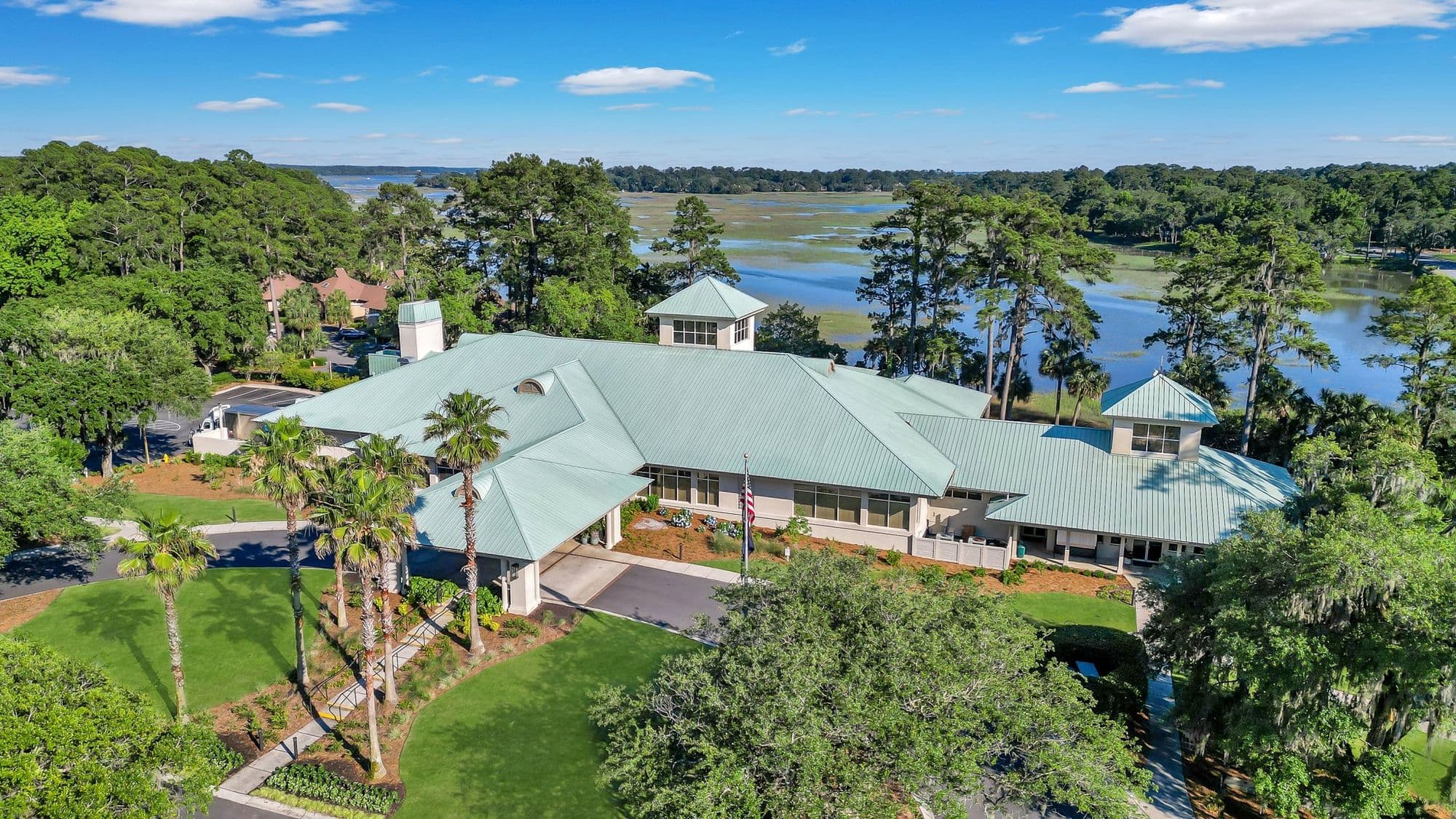 Aerial view of the Moss Creek clubhouse with the marsh and Colleton River behind it