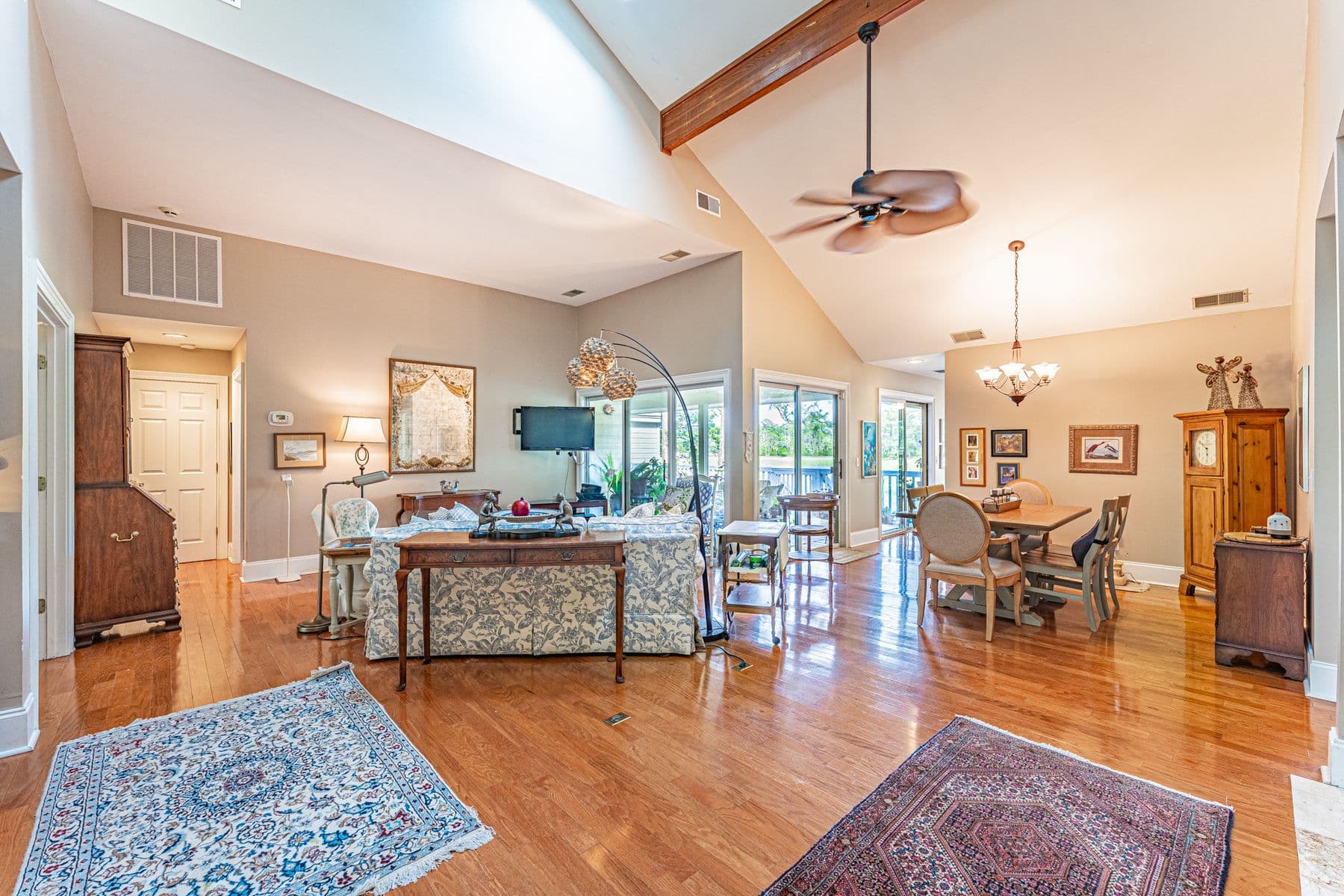 The vaulted living and dining room at 13 Marsh Winds, with hardwood floors