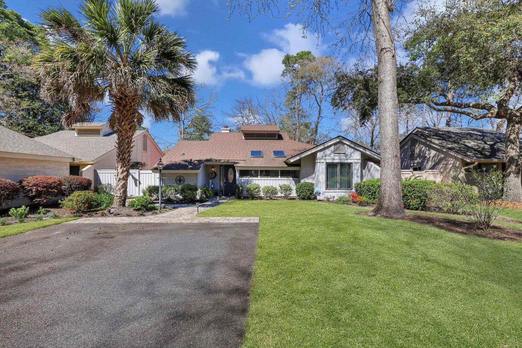 59 Stable Gate seen from the street, under palms and live oaks