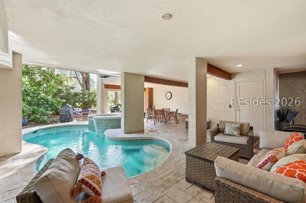 A pool and spa under the covered ground level of a Sea Pines townhouse, Hilton Head Island